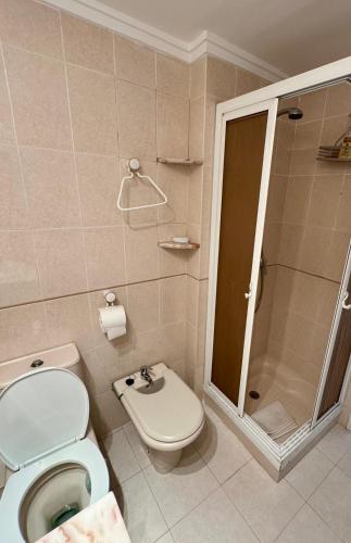 a bathroom with a toilet and a shower at 1st Line Beach Direct Access Private Parking in Valencia