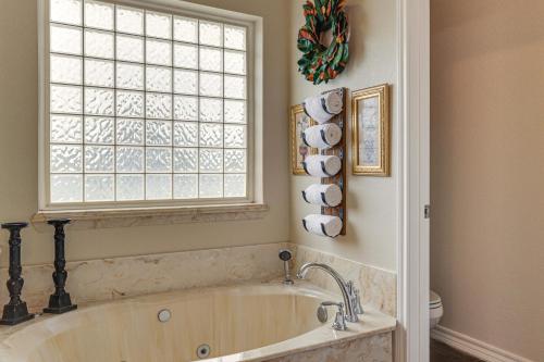 a bath tub in a bathroom with a window at 5 Acres! Countryside Getaway Outside Fort Worth in Crowley