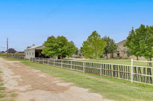 a white fence in front of a house at 5 Acres! Countryside Getaway Outside Fort Worth in Crowley