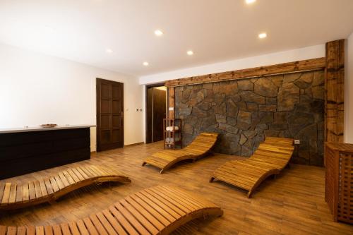 a room with two chairs and a stone wall at Hotel STARÝ MLÝN in Jeseník