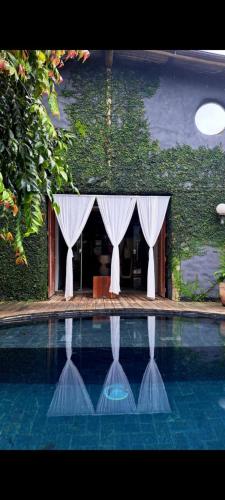 a wedding venue with a tent and a swimming pool at Loft Trancoso com Piscina & Jacuzzi in Trancoso