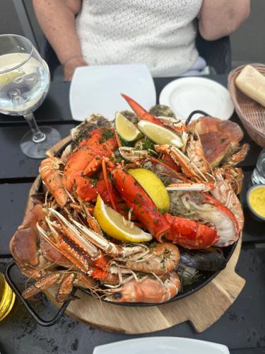 a plate of lobster and other seafood on a table at Ben Lomond Lodge in Rowardennan