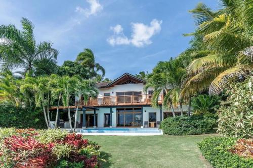 a house on the beach with palm trees at Samana Ocean View Villa in Los Grini