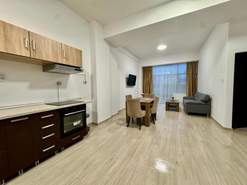 a living room with a kitchen and a dining room at Kim Urban Suites in Cluj-Napoca