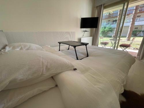 a white bed with a table on top of it at Le Loft Bleu Deauville - les Petites Planches in Deauville