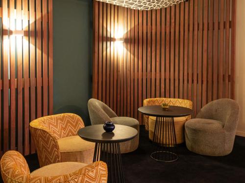 a waiting room with two tables and chairs at Ibis Marrakech Centre Gare in Marrakech