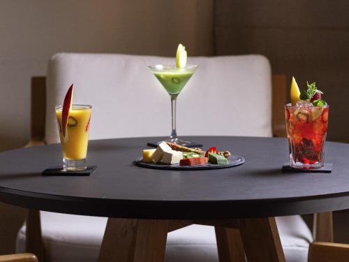 a table with a plate of food and two drinks at Ibis Marrakech Centre Gare in Marrakech