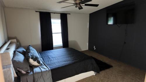 a bedroom with a bed and a ceiling fan at Faith short term rental in Romulus