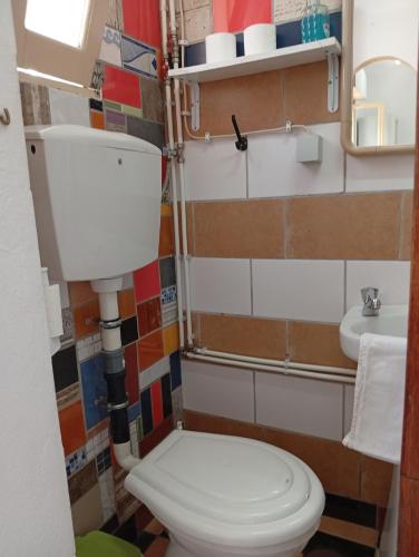 a bathroom with a toilet and a sink at Lagos Central Hostel in Lagos