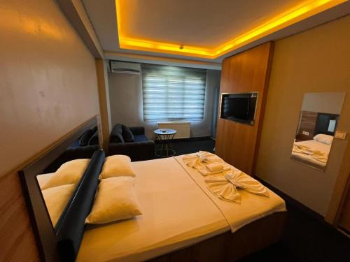 a small room with a bed and a couch at NEAR SUITES in Istanbul
