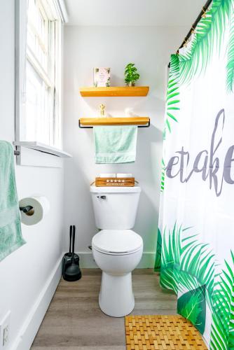 a bathroom with a toilet and a shower curtain at Prime Location Top Rated Clean Parking Free! in Chillicothe