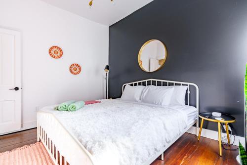 a bedroom with a white bed and a mirror at Prime Location Top Rated Clean Parking Free! in Chillicothe