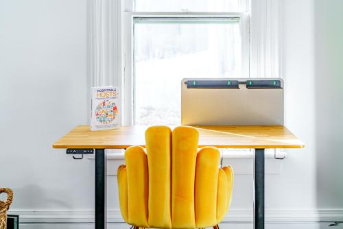 a wooden table with yellow chairs in front of a window at Prime Location Top Rated Clean Parking Free! in Chillicothe