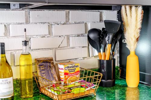 a counter with a basket of food and a bottle of wine at Prime Location Top Rated Clean Parking Free! in Chillicothe