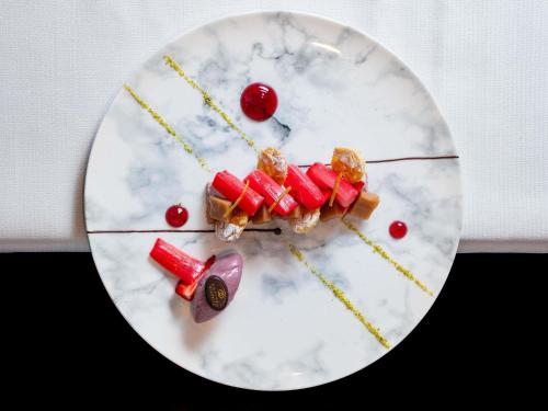 a white plate with some food on it at Sofitel Biarritz Le Miramar Thalassa in Biarritz