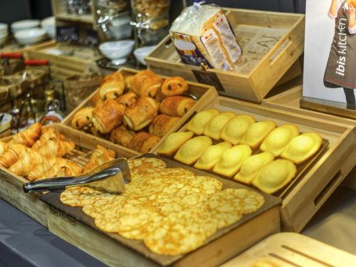 a buffet with many different types of bread and pastries at ibis Longwy Mexy in Mexy
