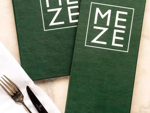 a green book with the word me next to a fork and knife at Novotel Melbourne Glen Waverley in Glen Waverley