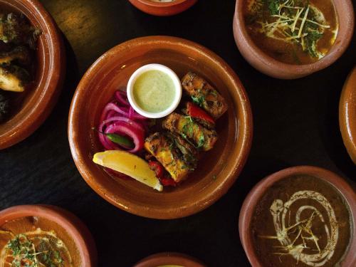 a table topped with plates of food and bowls of soup at Novotel Melbourne Glen Waverley in Glen Waverley