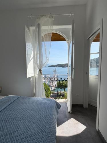 a bedroom with a bed and a view of the ocean at Le Finestre Veneris in Portovenere