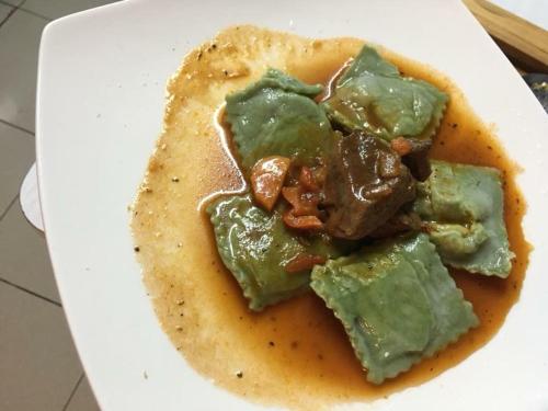 a plate of food with meat and sauce on a tortilla at Hain Casa Hotel in Punta Arenas