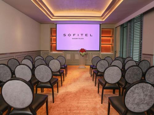 a conference room with chairs and a projection screen at Sofitel Saigon Plaza in Ho Chi Minh City