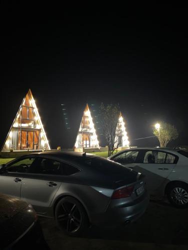 two cars parked in front of a building at night at Monark Villas in Shkodër