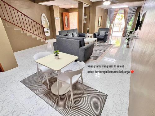 a living room with a couch and chairs and a table at D'Aya Sofea Homestay Padang Besar in Padang Besar