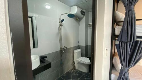 a small bathroom with a toilet and a sink at Tamcoc Sunseekers Homestay & Hostel in Ninh Binh