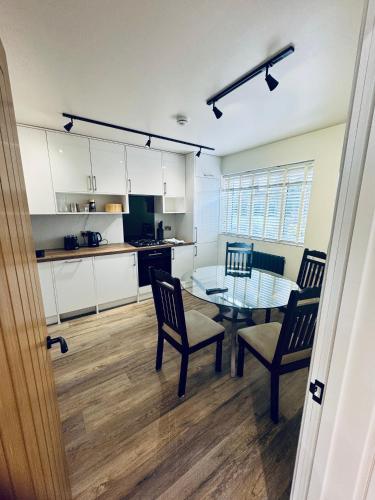 a kitchen and dining room with a table and chairs at 3 bedroom Brookwood Road apartment in Southampton