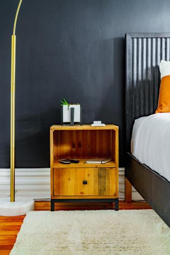 a bedroom with a bed and a wooden night stand at Short North Convention King Bed Free Parking! in Columbus