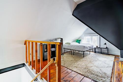 a staircase leading to a bedroom with a bed at Short North Convention King Bed Free Parking! in Columbus