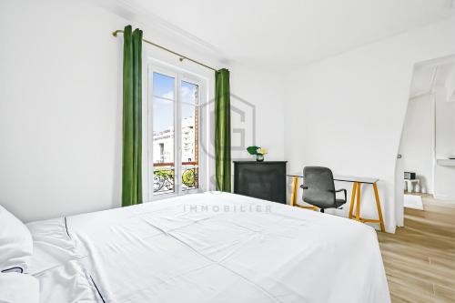 a bedroom with a white bed and a window at Gaspar- Passages- Comfort & proximity to Paris in Boulogne-Billancourt