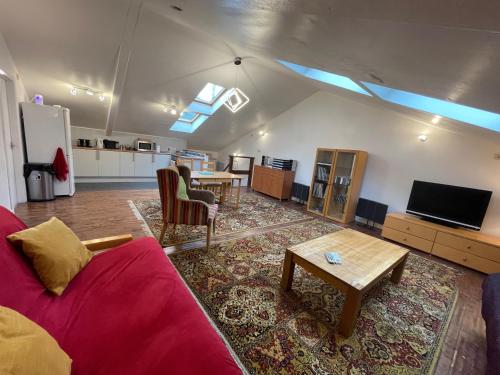 a living room with a couch and a table at Downlands Barn apartment 1 Bedroom - 2 Futon in Lounge in Ditchling