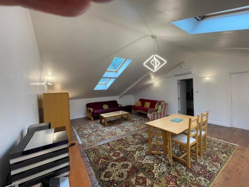 a living room with a table and a couch at Downlands Barn apartment 1 Bedroom - 2 Futon in Lounge in Ditchling