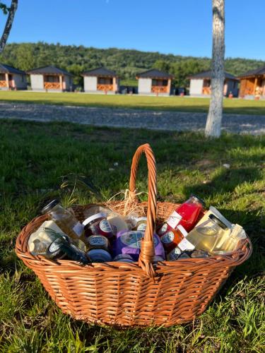 a basket full of beer and bottles in the grass at Eko farma Kladovo in Kladovo