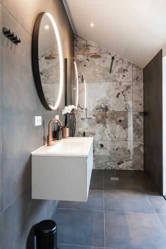 a bathroom with a white sink and a mirror at Cozy 2-Bedroom Apartment in Central Nijmegen in Nijmegen