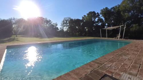a swimming pool with blue water in a yard at B & B Arzilla in Rosciano