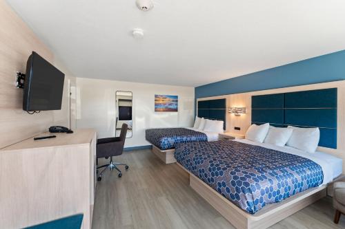 a hotel room with a bed and a desk at Pilgrim Sands on Long Beach in Plymouth