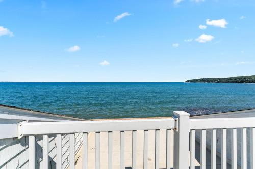 a view of the ocean from a white fence at Pilgrim Sands on Long Beach in Plymouth
