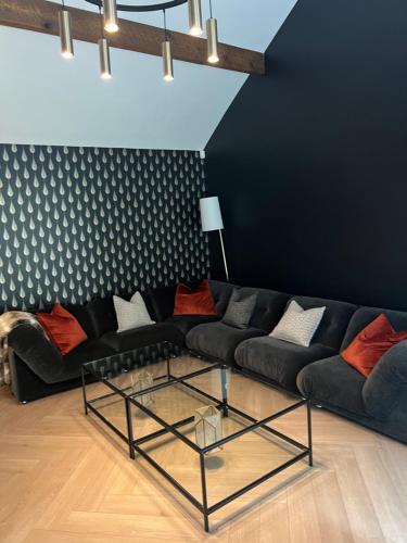 a living room with a couch and a glass table at Luxury Croft Templepatrick Near Airport Rabbit and Hilton hotel in Templepatrick
