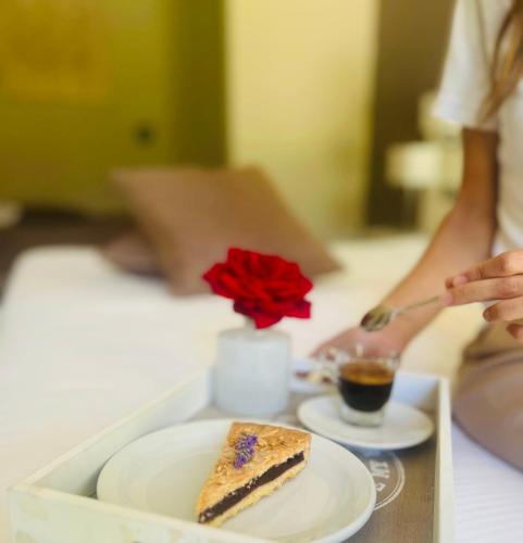 a person eating a piece of cake on a tray at The Florence Hills Resort & Wellness in Pelago