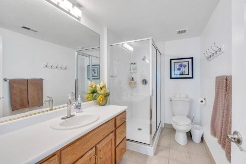 a bathroom with a sink and a shower and a toilet at Over The River in Riverton