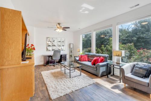 a living room with a couch and a tv at Over The River in Riverton