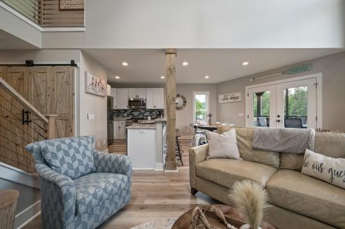 a living room with a couch and a chair at River Lofts - Onyx & Catawba Cottages in Hickory
