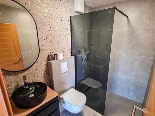 a bathroom with a shower and a toilet and a sink at Goldy in Neum