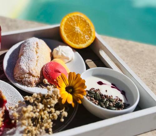a tray of food with a plate of food with desserts at The Florence Hills Resort & Wellness in Pelago