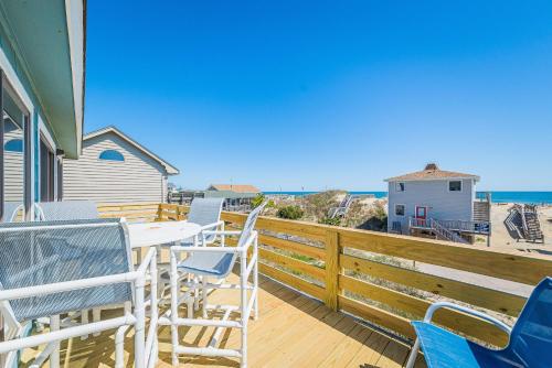 a balcony with chairs and a table and the ocean at Sea II Views in Whalebone