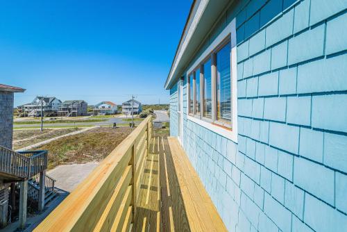 a porch of a house with a wooden deck at Sea II Views in Whalebone