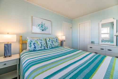 a bedroom with a bed and a desk with two lamps at Sea II Views in Whalebone