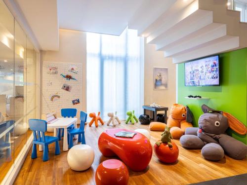 a room with many stuffed animals on the floor at Novotel Brussels City Centre in Brussels